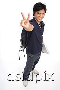 AsiaPix - Young man carrying books and a backpack, making peace sign
