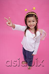 AsiaPix - Young girl wearing fairy wings and deely bopper, making peace sign