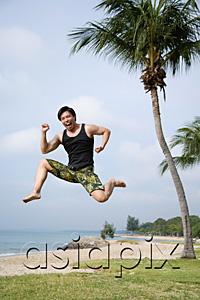 AsiaPix - Man jumping in air, looking at camera