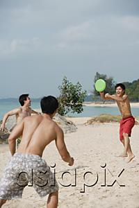 AsiaPix - Three men on beach playing with Frisbee