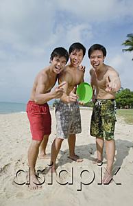 AsiaPix - Three men on beach, standing side by side, making hand sign