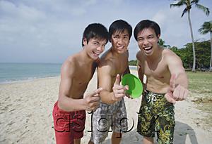 AsiaPix - Men on beach, standing side by side, making hand sign