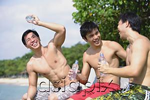 AsiaPix - Three men sitting side by side, holding bottle of water