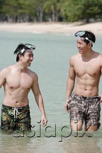 AsiaPix - Two men wading in sea, wearing goggles