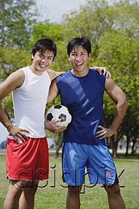 AsiaPix - Two men standing together, one holding soccer ball