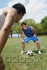 AsiaPix - Two men on field, taking a break from soccer game
