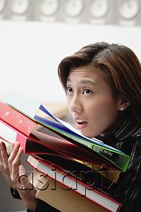 AsiaPix - Female executive carrying folders and binders