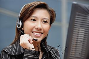 AsiaPix - Female executive with hands free device