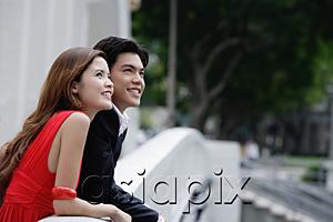 AsiaPix - Couple leaning over bridge railing, looking away