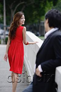 AsiaPix - Woman looking over shoulder at man behind her