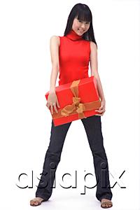 AsiaPix - Young woman standing with big red gift box