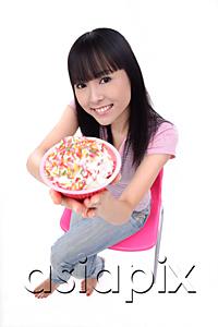 AsiaPix - Young woman offering bowl of ice cream