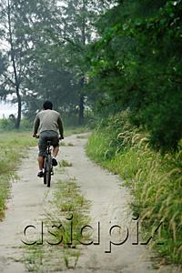 AsiaPix - Rear view of a man cycling