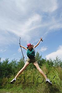 AsiaPix - Female hiker, jumping, arms outstretched
