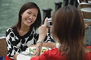 AsiaPix - Woman taking a picture of another woman