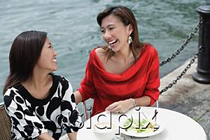 AsiaPix - Two women at sidewalk cafe having lunch, high angle view