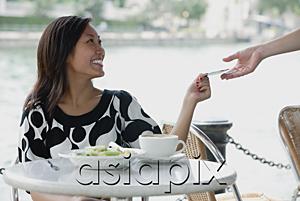 AsiaPix - Young woman at cafe, paying with credit card