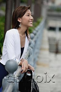 AsiaPix - Woman leaning on railing, looking away