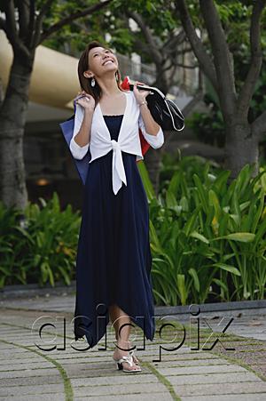 AsiaPix - Woman carrying shopping bags, looking up