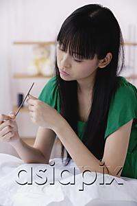 AsiaPix - Young woman filing nails