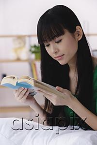 AsiaPix - Young woman reading a book