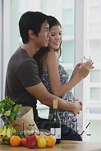 AsiaPix - Couple at home, man embracing woman from behind