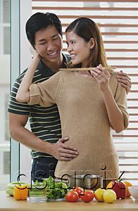 AsiaPix - Man embracing woman from behind, woman feeding man