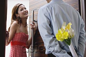 AsiaPix - Woman opening door, man with flowers behind his back