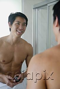 AsiaPix - Man in bathroom, looking at mirror