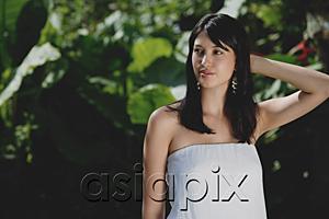 AsiaPix - Young woman in tropical garden, looking away