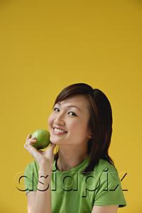 AsiaPix - Young Woman holding apple