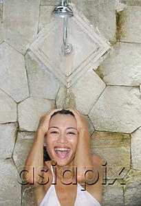 AsiaPix - Young woman under shower, smiling