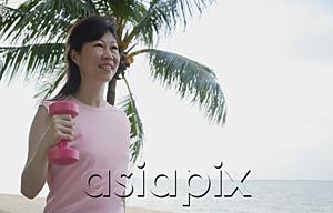 AsiaPix - Mature woman using dumbbell outdoors