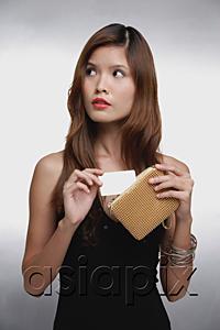 AsiaPix - Woman in black top, putting credit card into purse