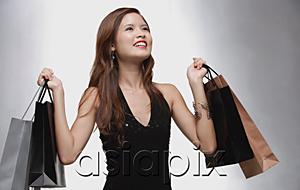 AsiaPix - Woman in black top carrying shopping bags