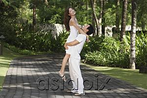 AsiaPix - Couple in garden, man carrying woman