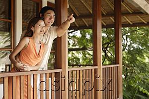 AsiaPix - Couple standing in balcony, man pointing in the distance