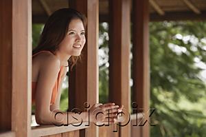 AsiaPix - Woman standing in balcony, looking out
