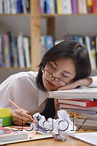 AsiaPix - Young woman in library, sleeping on stack of books