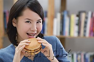 AsiaPix - Young woman eating a burger