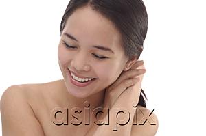 AsiaPix - Young woman with eyes closed, smiling
