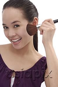 AsiaPix - Young woman applying make-up