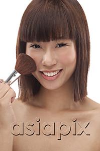 AsiaPix - Young woman applying blusher