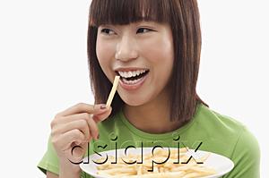 AsiaPix - Young woman eating French fries