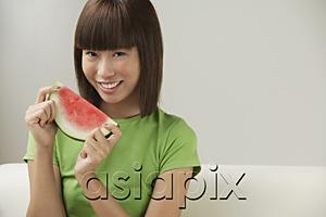 AsiaPix - Young woman holding a slice of watermelon
