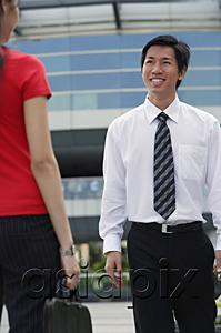 AsiaPix - Male executive smiling at woman in front of him
