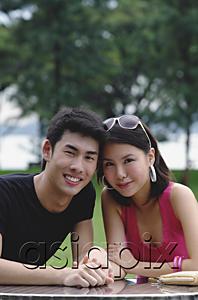 AsiaPix - Couple sitting side by side, smiling at camera