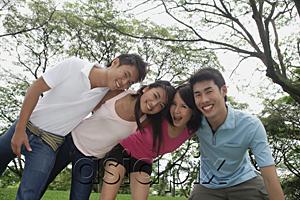 AsiaPix - Young adults in park, side by side, embracing