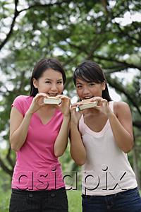 AsiaPix - Two women eating ice cream, looking at camera