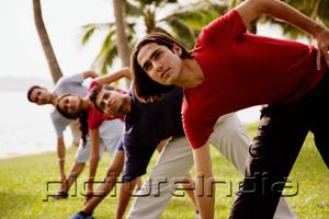 PictureIndia - Young adults doing stretching exercises, bending sideways